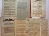 several old papers are sitting on top of each other on a table
