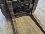 a forklift that is sitting in the middle of the floor