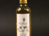 a bottle of olive oil on a black background