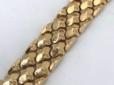 gold plated bracelet with a snake skin pattern on it