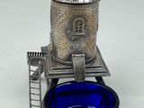 a blue glass bowl with a windmill on top of it