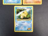 three pokemon cards are sitting on a table with a black background