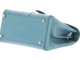blue leather purse with metal studs on top of a white background