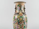 an image of a vase with a lot of flowers on it