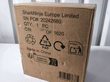 the box is open on a white table with a white background