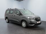 the grey van is parked in a large room with a black floor