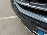a close up of a car ' s grille with a cat on it