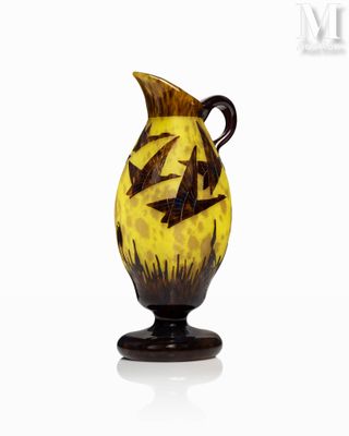 a yellow vase with black birds on it on a white surface