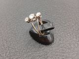 a close up of a ring on a table with a black surface