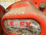 a close up of a red fire hydrant with a chain attached to it