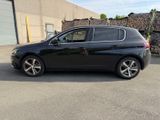 a picture of a black car parked in front of a building