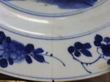 a blue and white plate with a picture of a monkey on it