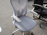 a white office chair that is sitting in the middle of a room