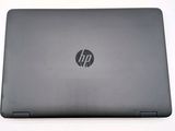 hp laptop on a white surface with a logo on the screen