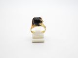 a close up of a gold ring with a black stone