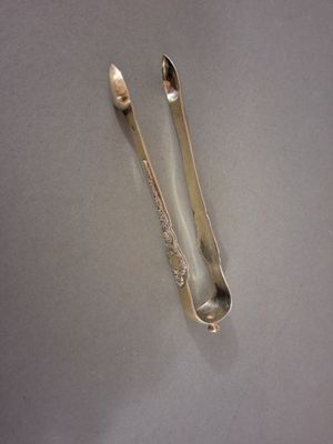 two spoons and a spoon rest on a table