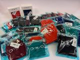 a lot of men ' s clothing in bags on the table