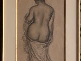 an old drawing of a woman in a towel is hanging on a wall