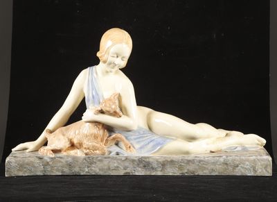 a figurine of a woman laying down with a cat