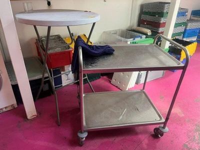 a metal cart with a tray on it in a room