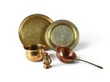several different types of brass dishes and spoons on a white surface