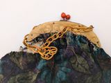 a purse with a chain on it sitting on a table