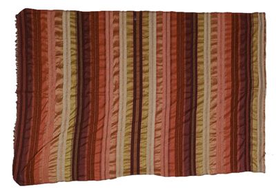 an orange and brown striped rug on a white background