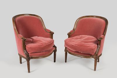 pair of pink velvet armchairs with carved wood legs