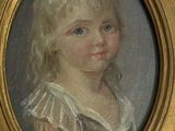 portrait of a young girl in a gold frame with blue eyes
