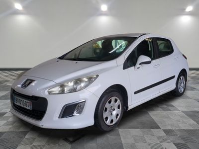 the small white car is parked in a room with a checkered floor