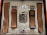 an orange box containing a watch, a watch and a watch strap