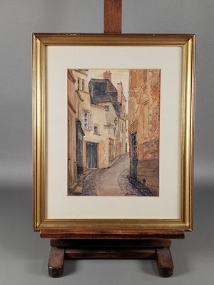 une image d'une peinture représentant une scène de rue dans un cadre doré