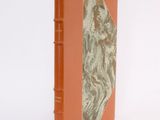 an orange book with a picture of a woman on it