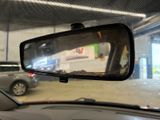 a rear view mirror of a car in a parking garage