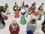 many figurines of people that are standing in a circle