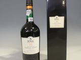 a bottle of wine sitting next to a black box