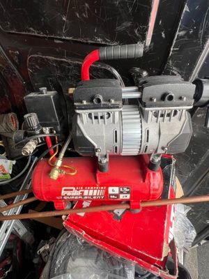 an image of a red air compressor sitting on top of a table