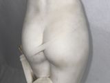 marble statue of a female nude torso holding a book