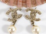 chanel earrings with pearls and crystals on a seashell