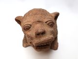 a small statue of a cat on a white surface