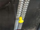 a close up view of a car ' s radiator with a yellow button on it