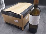 a bottle of wine sitting next to a box of wine