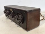 an old radio sitting on top of a white table