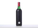 a bottle of wine sitting on top of a white counter