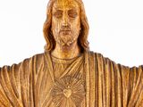 a statue of jesus holding his hands out in front of a white background