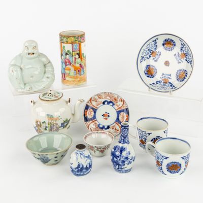 a collection of asian ceramics on display on a white surface