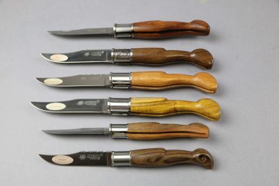 six different types of knifes are lined up on a table