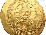 a close up of a gold coin with a picture of jesus on it
