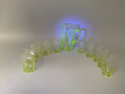 a group of glasses and a pitcher on a table