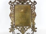 an antique brass frame with a decorative design on it